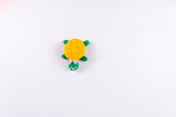 Turtle with LEDs between its orange shell and its head