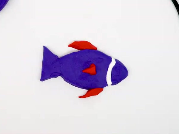 Purple dough fish with red dough fins