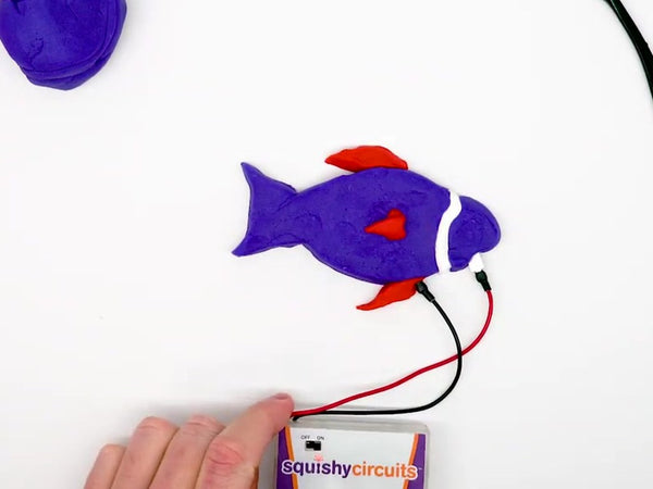 Purple fish with an LED eye, wired to the battery holder