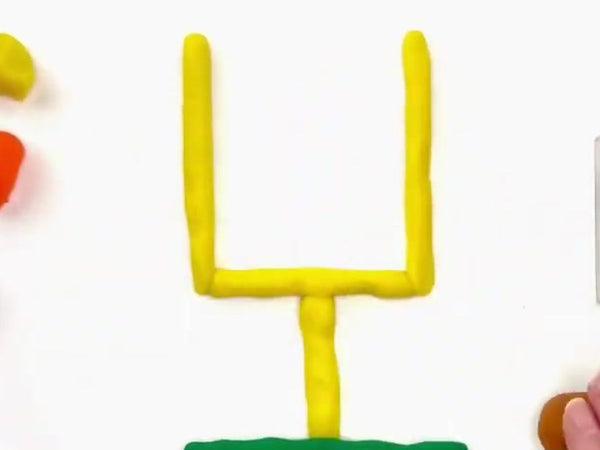Yellow goalpost on a green dough field