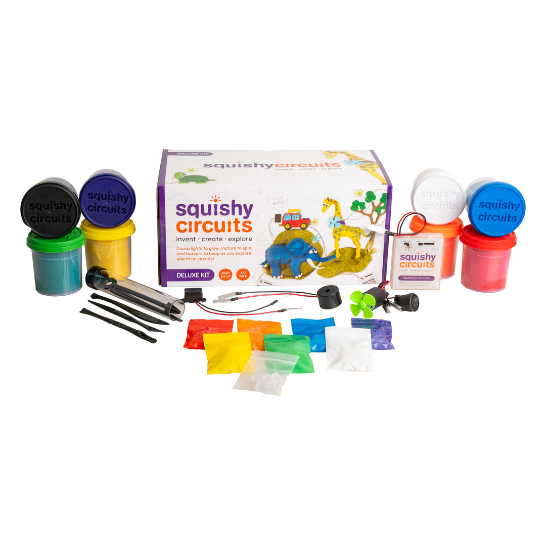 Squishy Circuits Deluxe Kit contents laid out: 8 tubs of dough, LEDs, motor with fan, two buzzers, switch, battery holder with pulse slider and sculpting tools
