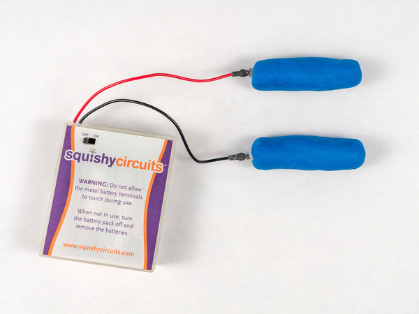 Two blue dough pieces wired to the battery holder