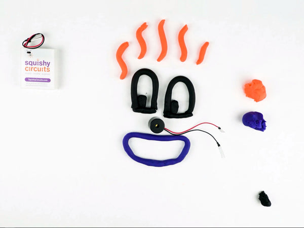 Face with black eyes, a purple smile and wavy orange hair