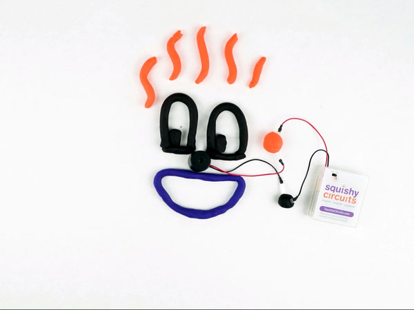 Silly face with a buzzer nose, wired to the battery holder