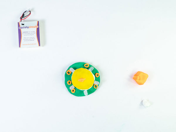 UFO with orange dough vent rings around the green disc