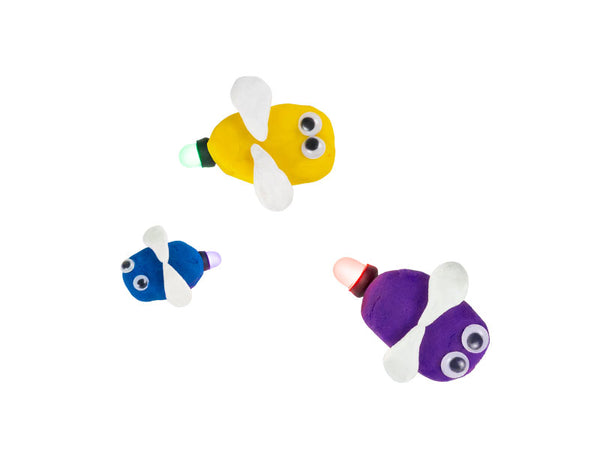 Yellow, blue and purple dough fireflies with white wings and googly eyes
