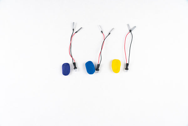 Three wired LEDs next to blue and yellow dough firefly bodies