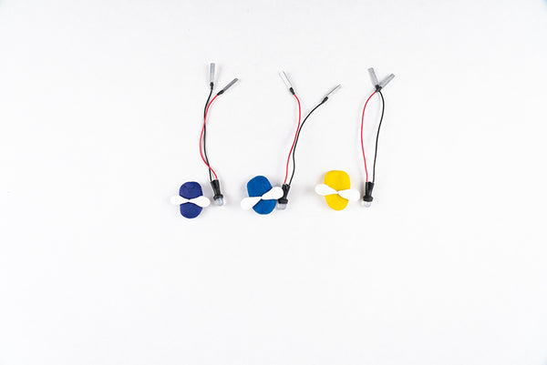 Three firefly bodies with white dough wings, each next to a wired LED