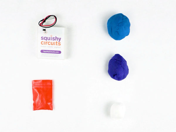 Blue and purple dough next to the battery holder