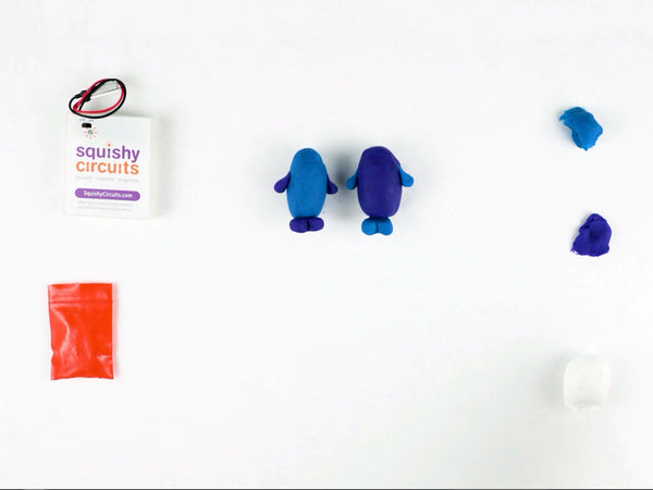 Two dough buddies with arms, feet and eyes